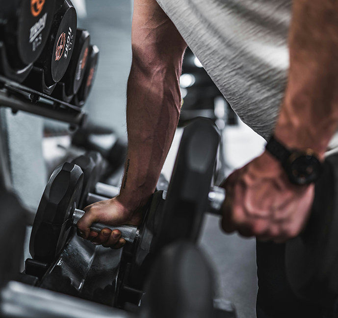 Man picking up dumbbells